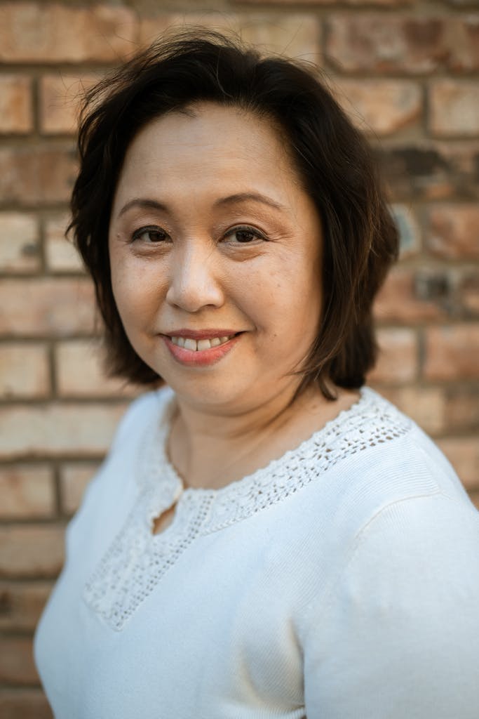 Woman in White Lace Top Smiling